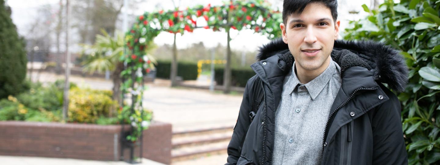 Young man standing outside looking at the camera